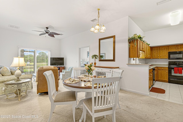 carpeted dining room featuring ceiling fan with notable chandelier