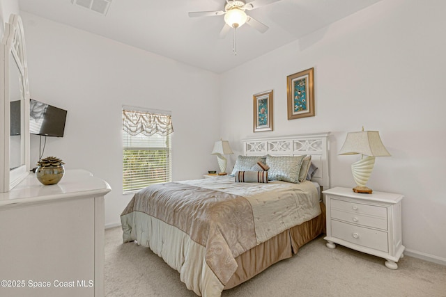 bedroom with ceiling fan and light colored carpet