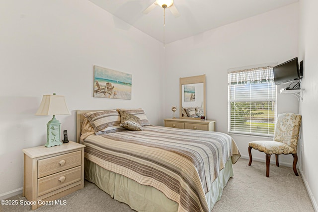 carpeted bedroom featuring high vaulted ceiling and ceiling fan