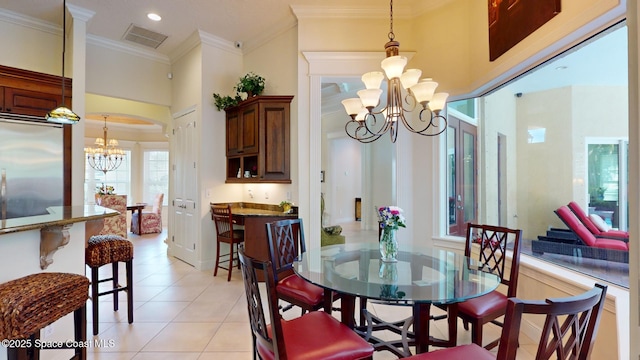 dining area with an inviting chandelier, ornamental molding, light tile patterned flooring, and a high ceiling