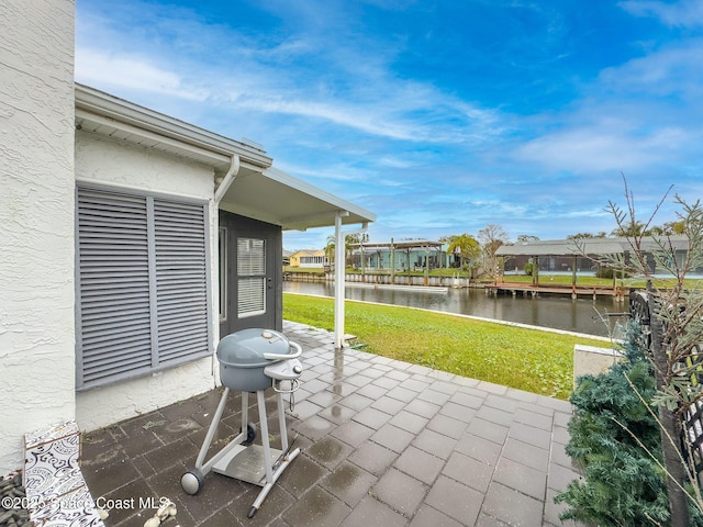 view of patio / terrace with a water view and a grill