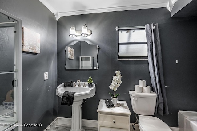 bathroom with crown molding and toilet