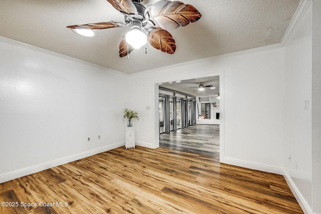 unfurnished room with ceiling fan, crown molding, a textured ceiling, and hardwood / wood-style flooring