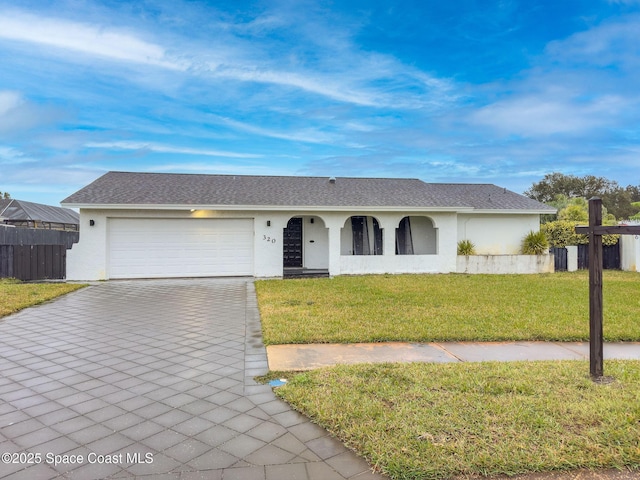 ranch-style house with a garage and a front lawn