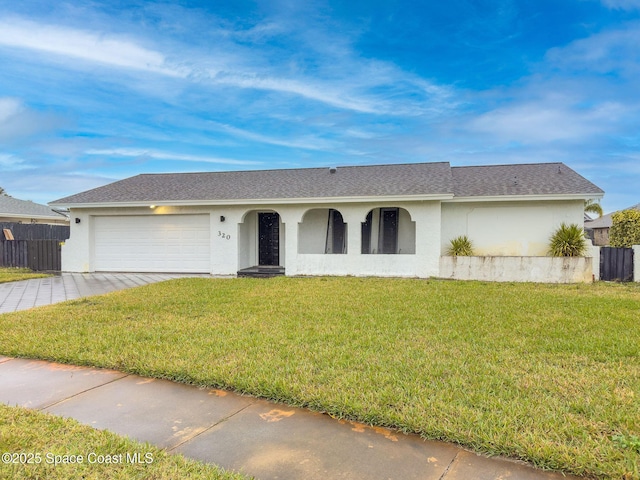 single story home with a garage and a front yard