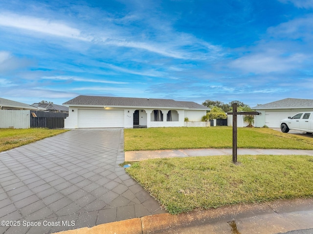 single story home featuring a garage and a front yard