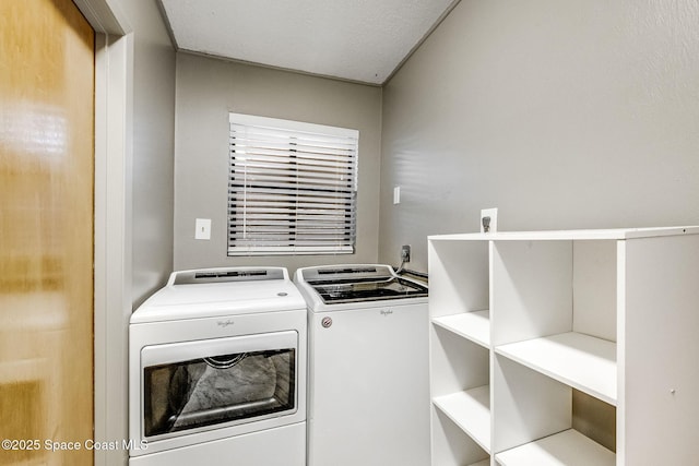 clothes washing area featuring washer and clothes dryer