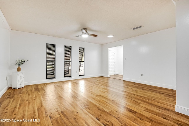 empty room with ceiling fan and hardwood / wood-style floors