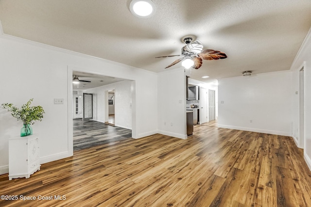 unfurnished living room featuring hardwood / wood-style floors, crown molding, a textured ceiling, and ceiling fan