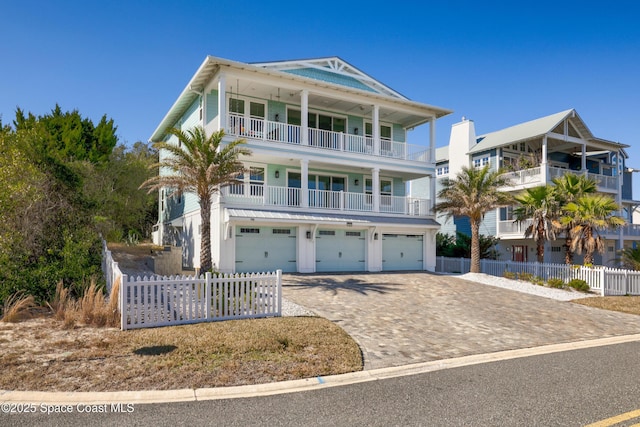 view of front of home featuring a garage and a balcony