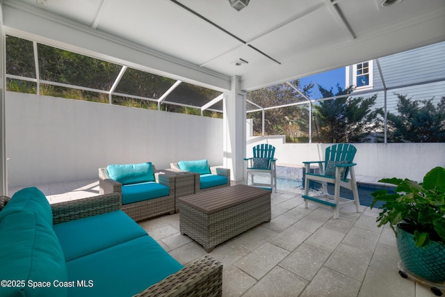 view of patio with outdoor lounge area and glass enclosure