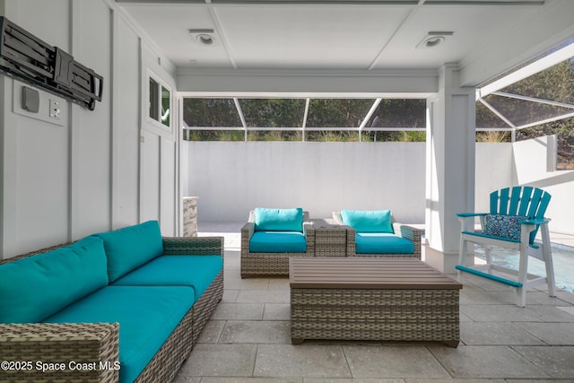 view of patio featuring outdoor lounge area and a lanai