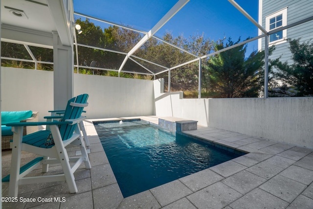 view of swimming pool with a patio area and glass enclosure