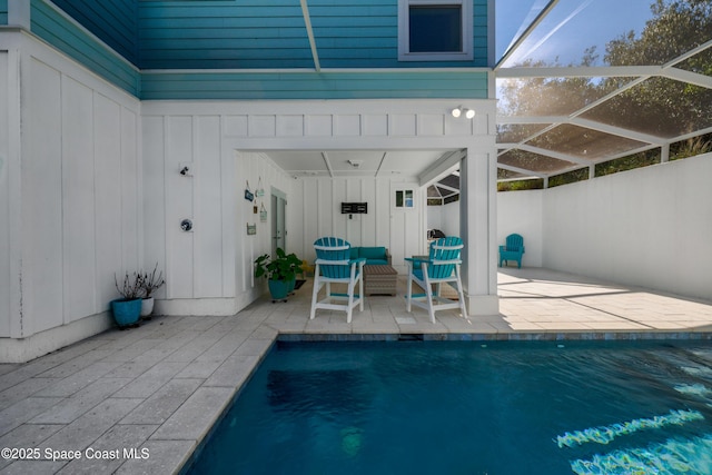 view of pool featuring a patio and glass enclosure