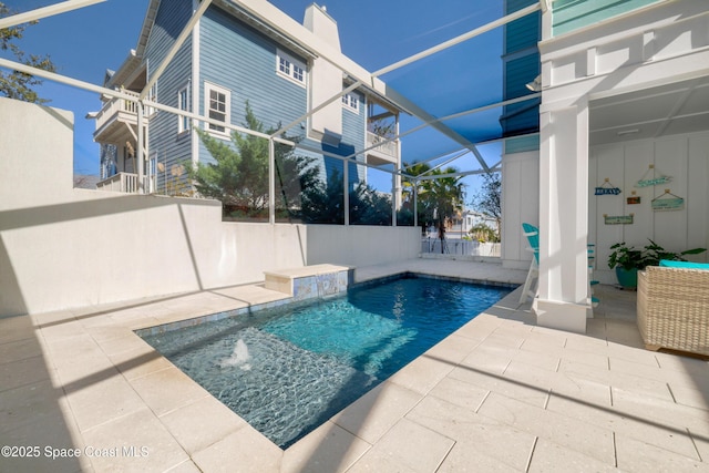 view of swimming pool with a patio, a lanai, and pool water feature