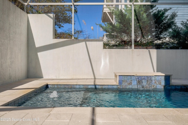 view of swimming pool featuring pool water feature and a lanai