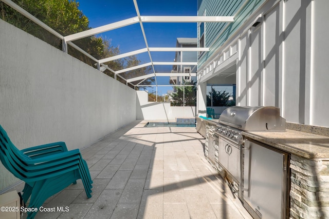 view of patio featuring area for grilling, a lanai, a swimming pool, and an outdoor kitchen