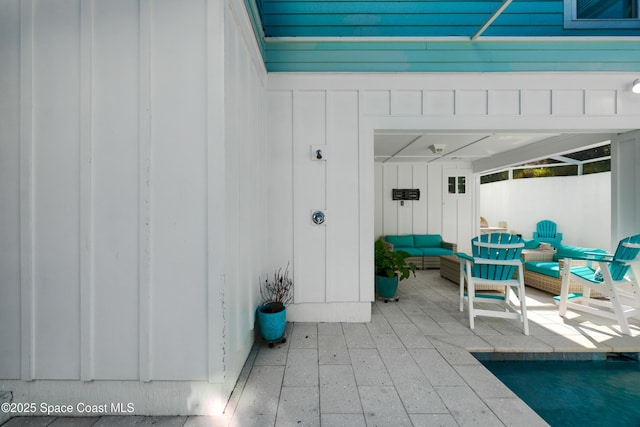 property entrance with an outdoor living space and a patio