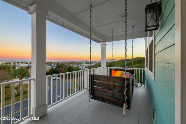 view of balcony at dusk