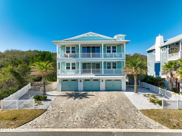 beach home with a garage and a balcony