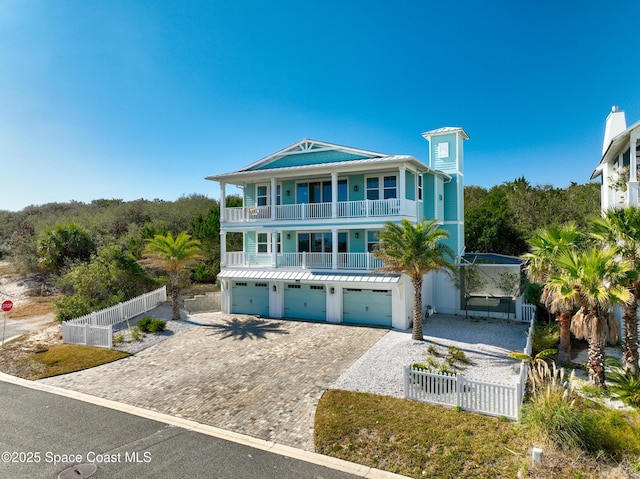 beach home featuring a balcony and a garage