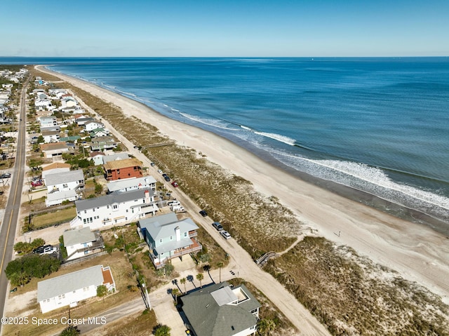 birds eye view of property with a view of the beach and a water view