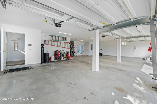 garage with a garage door opener and electric panel