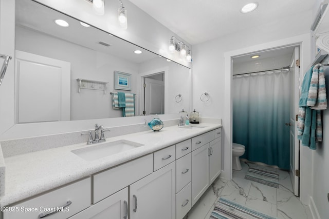 bathroom featuring vanity and toilet