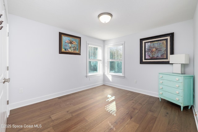 unfurnished bedroom with dark hardwood / wood-style flooring