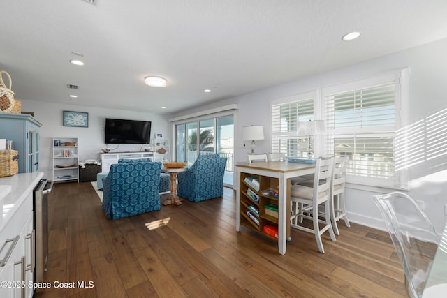 dining area with dark hardwood / wood-style floors