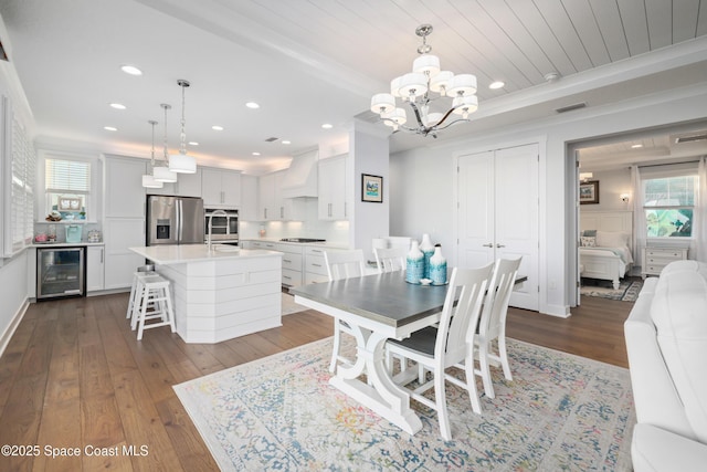 dining space with wood ceiling, hardwood / wood-style flooring, beverage cooler, and beamed ceiling