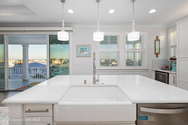 kitchen featuring white cabinets, ornamental molding, pendant lighting, and wine cooler