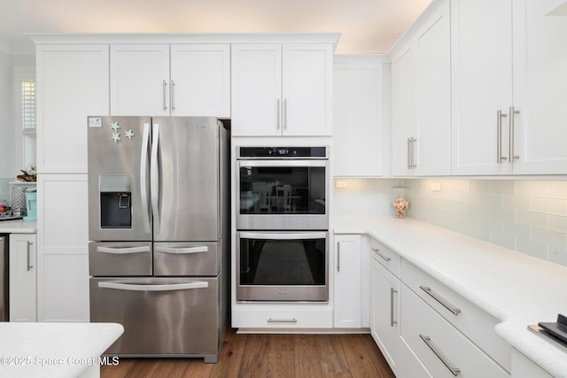 kitchen featuring dark hardwood / wood-style flooring, white cabinets, and appliances with stainless steel finishes