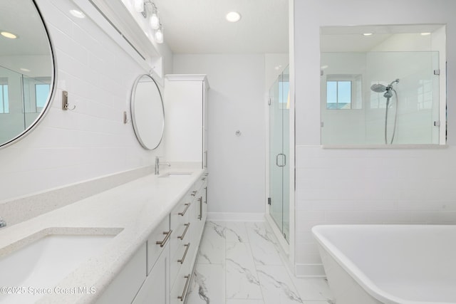 bathroom featuring vanity and separate shower and tub