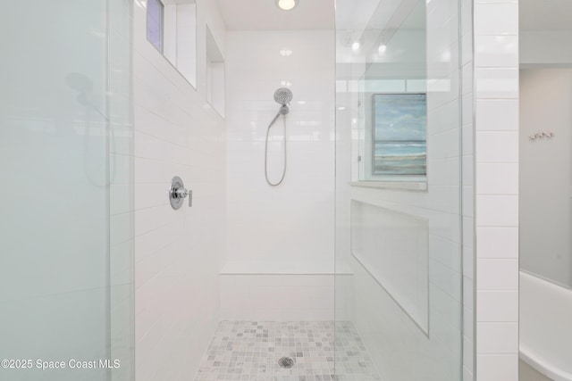 bathroom featuring a tile shower