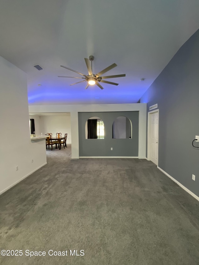 carpeted spare room featuring ceiling fan and vaulted ceiling