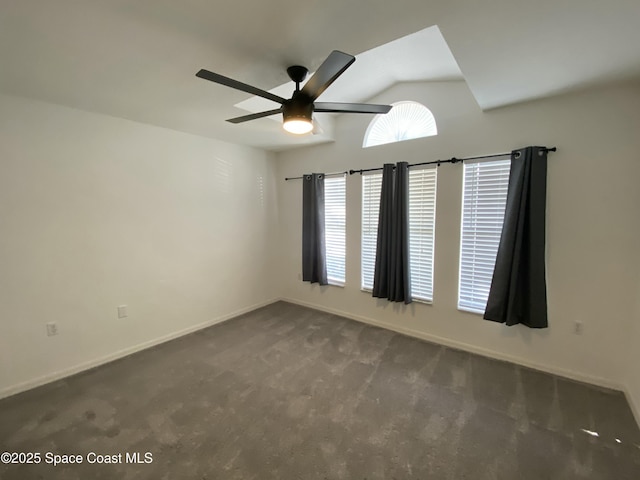 carpeted spare room with ceiling fan and lofted ceiling