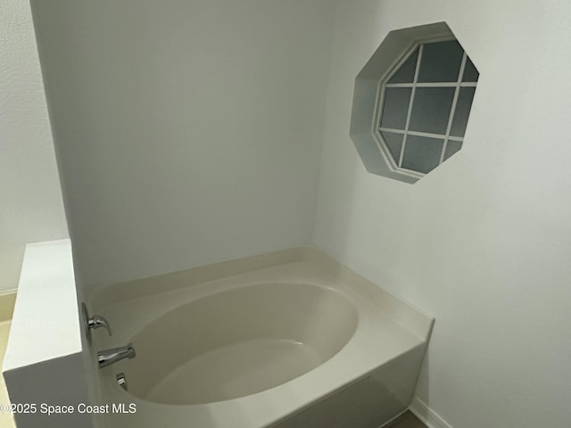 bathroom featuring a tub to relax in