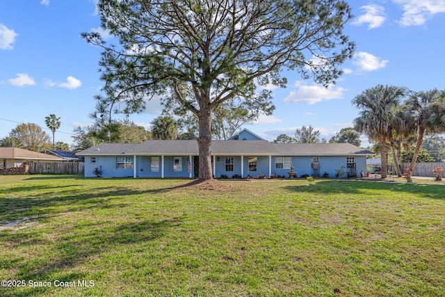 ranch-style house with fence and a front lawn