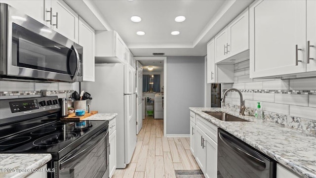 kitchen featuring white cabinetry, black dishwasher, sink, and range with electric stovetop