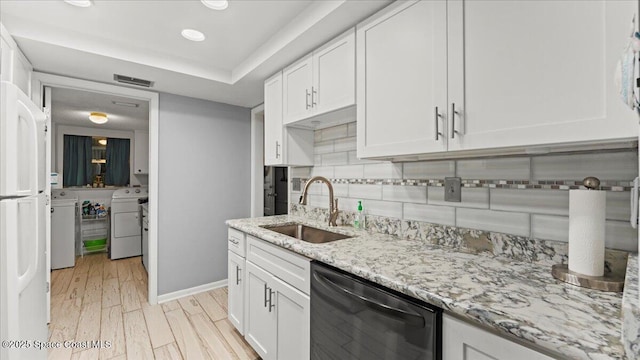 kitchen with dishwasher, sink, light stone countertops, and white cabinets