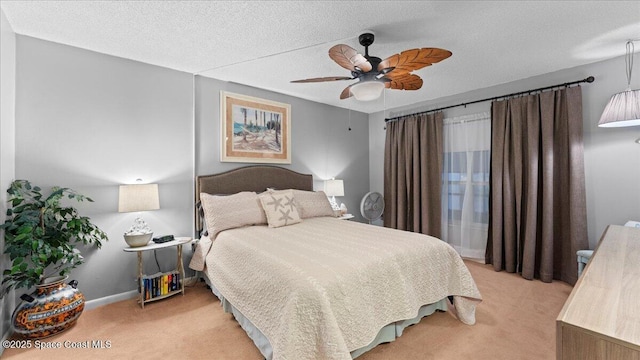 carpeted bedroom featuring a textured ceiling and ceiling fan