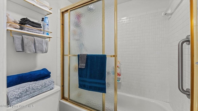 bathroom with bath / shower combo with glass door