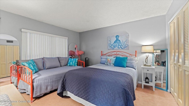 carpeted bedroom featuring a textured ceiling