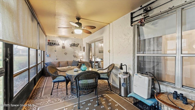 sunroom / solarium with ceiling fan