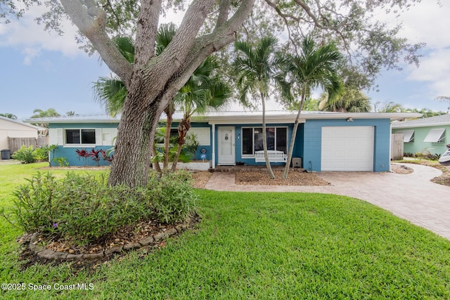 ranch-style house with a garage and a front lawn