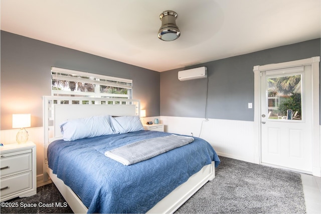 bedroom featuring ceiling fan, a wall mounted air conditioner, and multiple windows