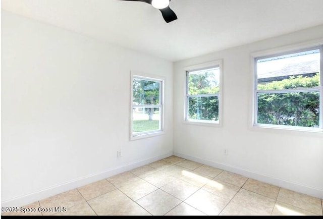 tiled spare room with ceiling fan