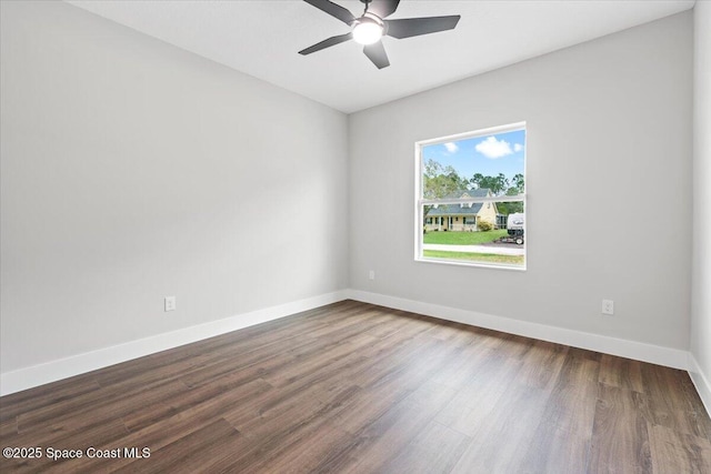 spare room featuring ceiling fan and dark wood-type flooring