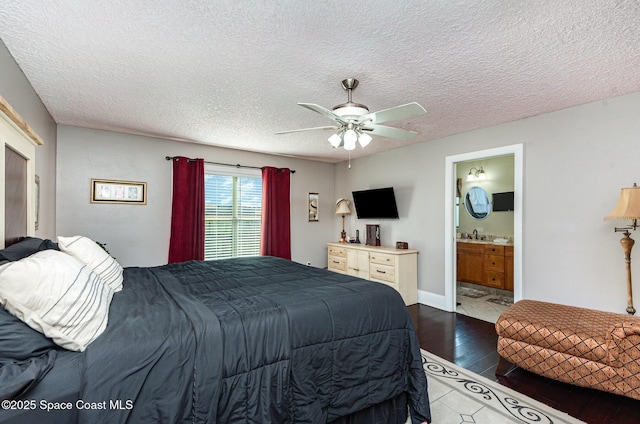 bedroom featuring ensuite bathroom, wood-type flooring, sink, ceiling fan, and a textured ceiling